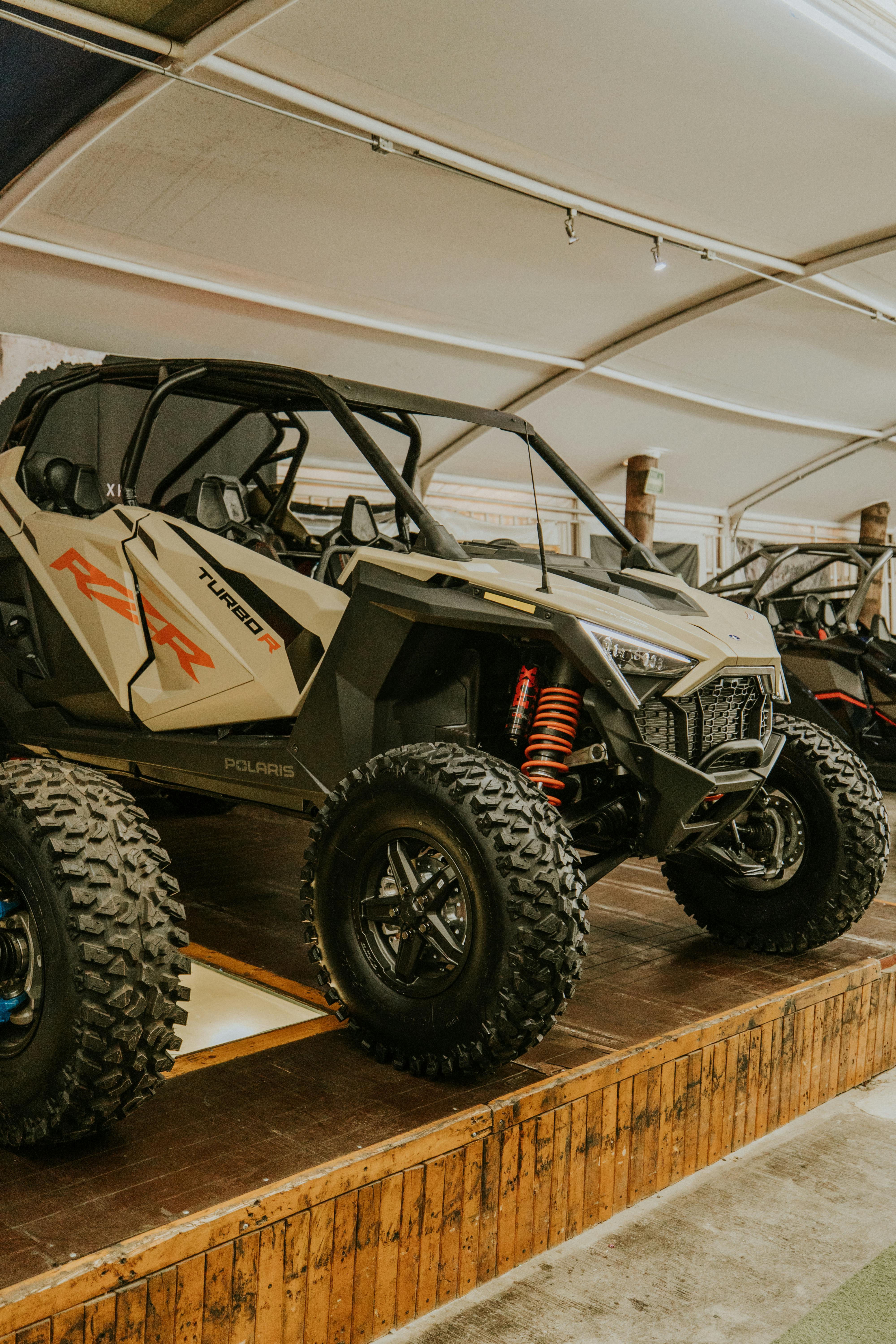 A powerful side-by-side vehicle showcased in an indoor setting, highlighting its robust design.