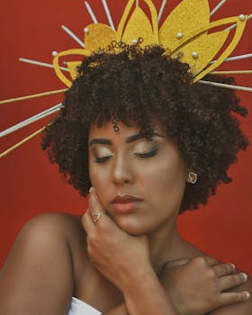 Portrait of a woman with eyes closed, showcasing elegant headdress in vibrant setting.
