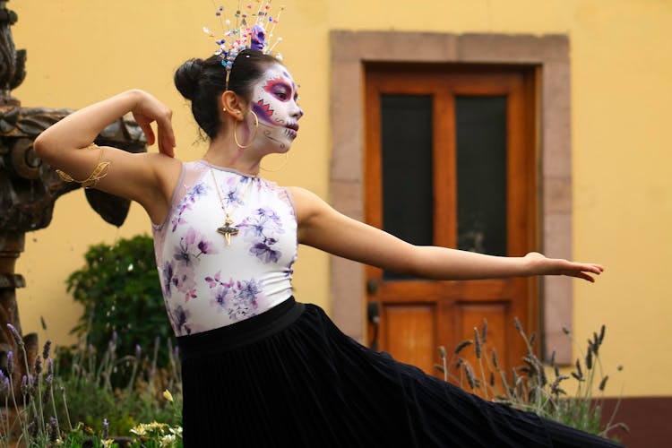 Woman Dressed As A Catrina Dancing Outside 