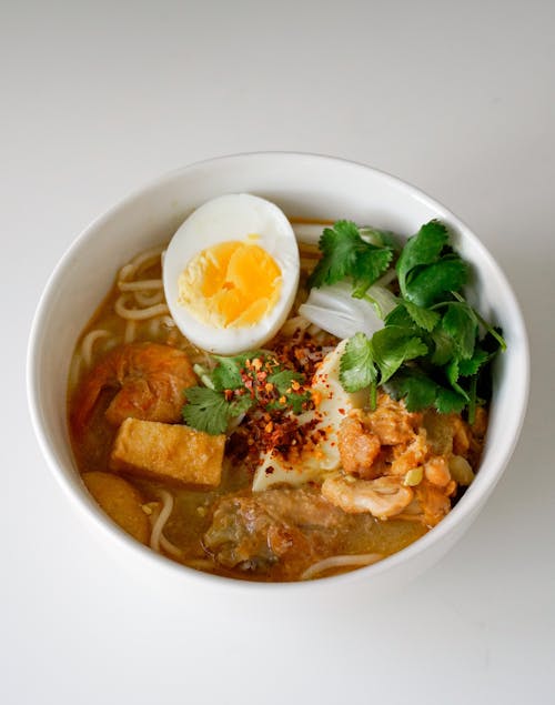 Bowl of Coconut Noodle Soup with Egg