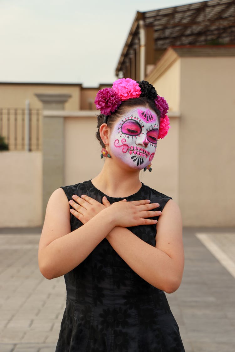 Woman Dressed As A Catrina Standing Outside 