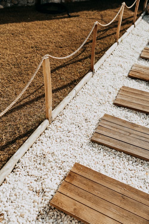 A Boardwalk on the Ground with Pebbles 