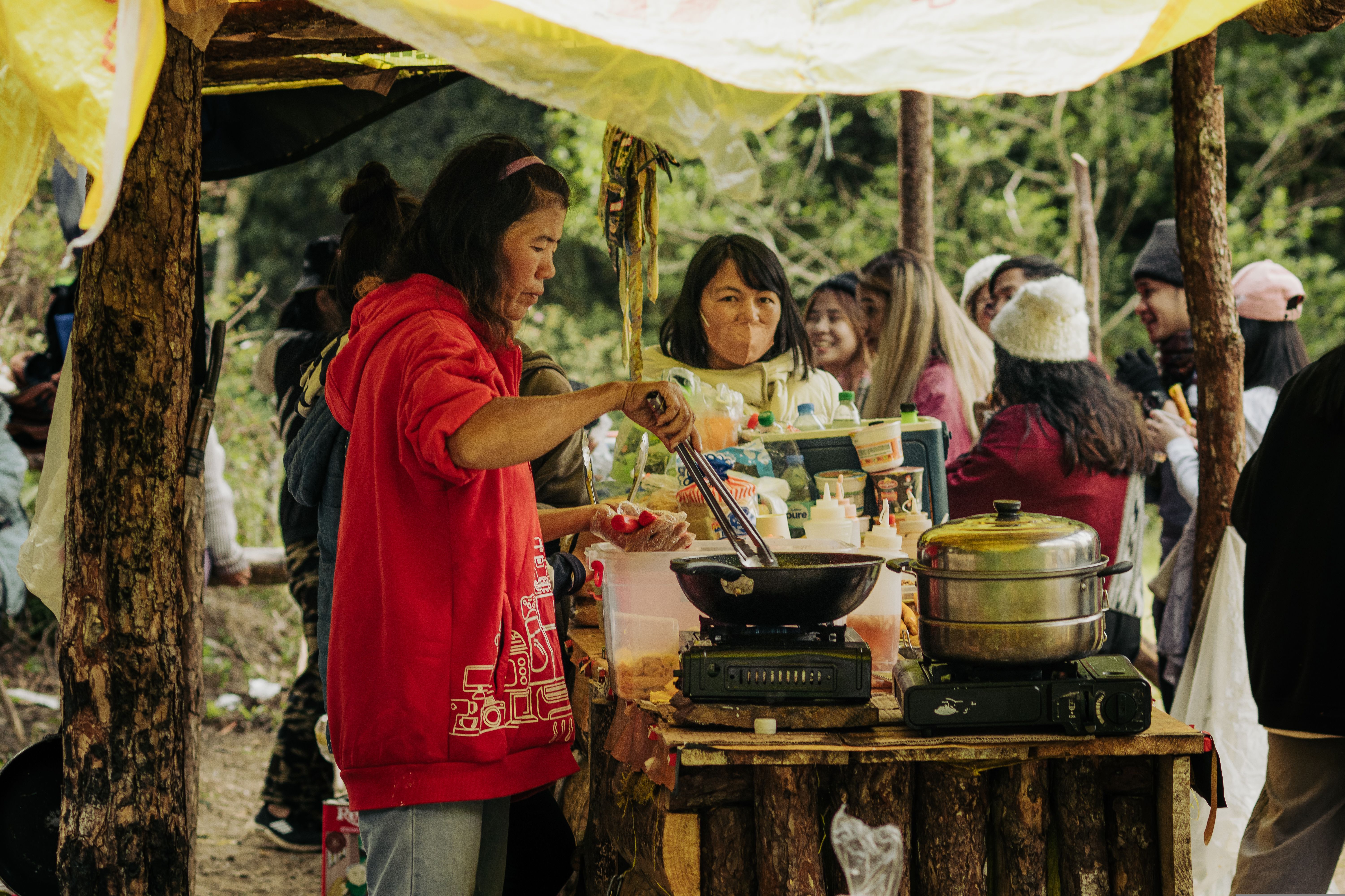 Women Cooking on Food Stand · Free Stock Photo