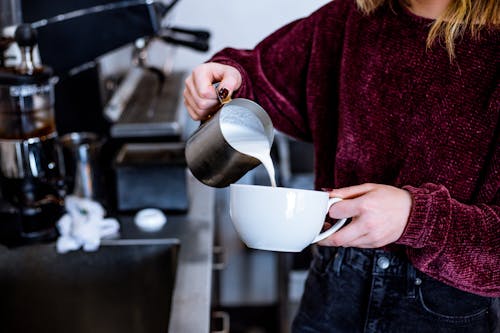 Free Woman Pouring Milk on Cup Stock Photo