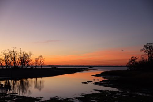 Free Tranquil sunrise at Cove Island Park, Stamford, CT, with reflections and vibrant colors. Stock Photo