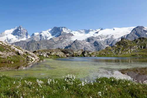 Free Breathtaking view of snowcapped peaks and clear lake in La Grave, France. Stock Photo