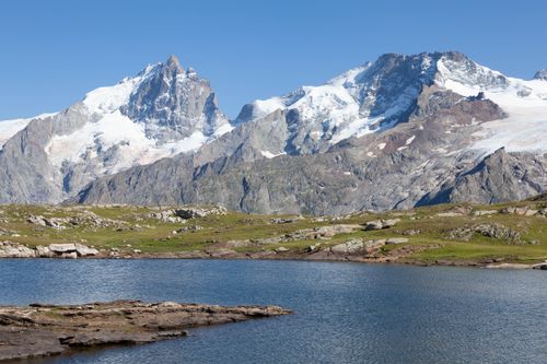 Free Stunning view of snowcapped mountains and a serene lake in La Grave, France. Stock Photo