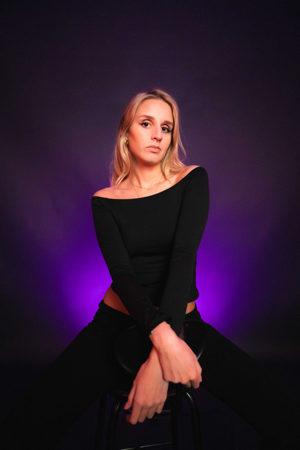 Studio portrait on a purple background with soft lighting