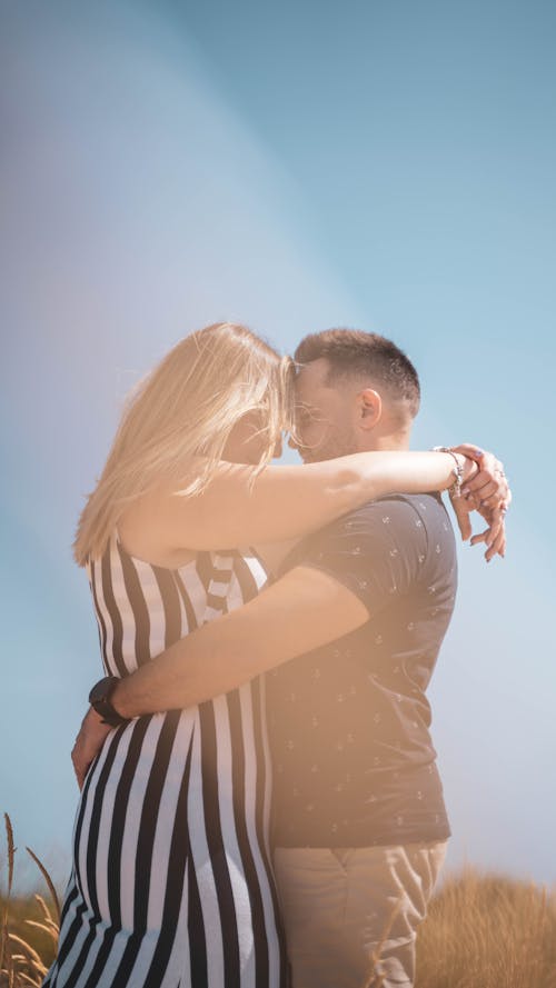 Young Couple Standing Face to Face and Embracing 