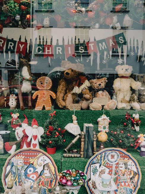 Festive store window showcasing Christmas decorations, toys, and ornaments.