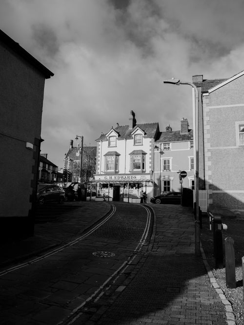 Free Charming black and white street scene in Conwy, Wales with historic architecture and paving stones. Stock Photo