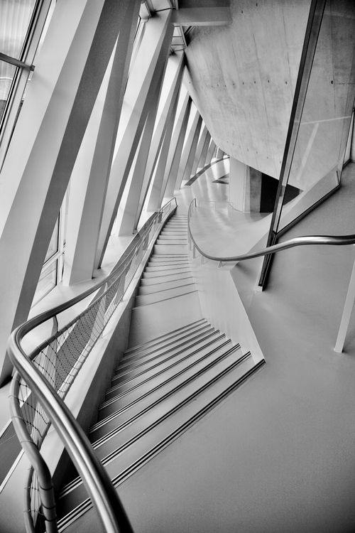 Free Black and white view of modern staircase with unique architectural design and handrails. Stock Photo