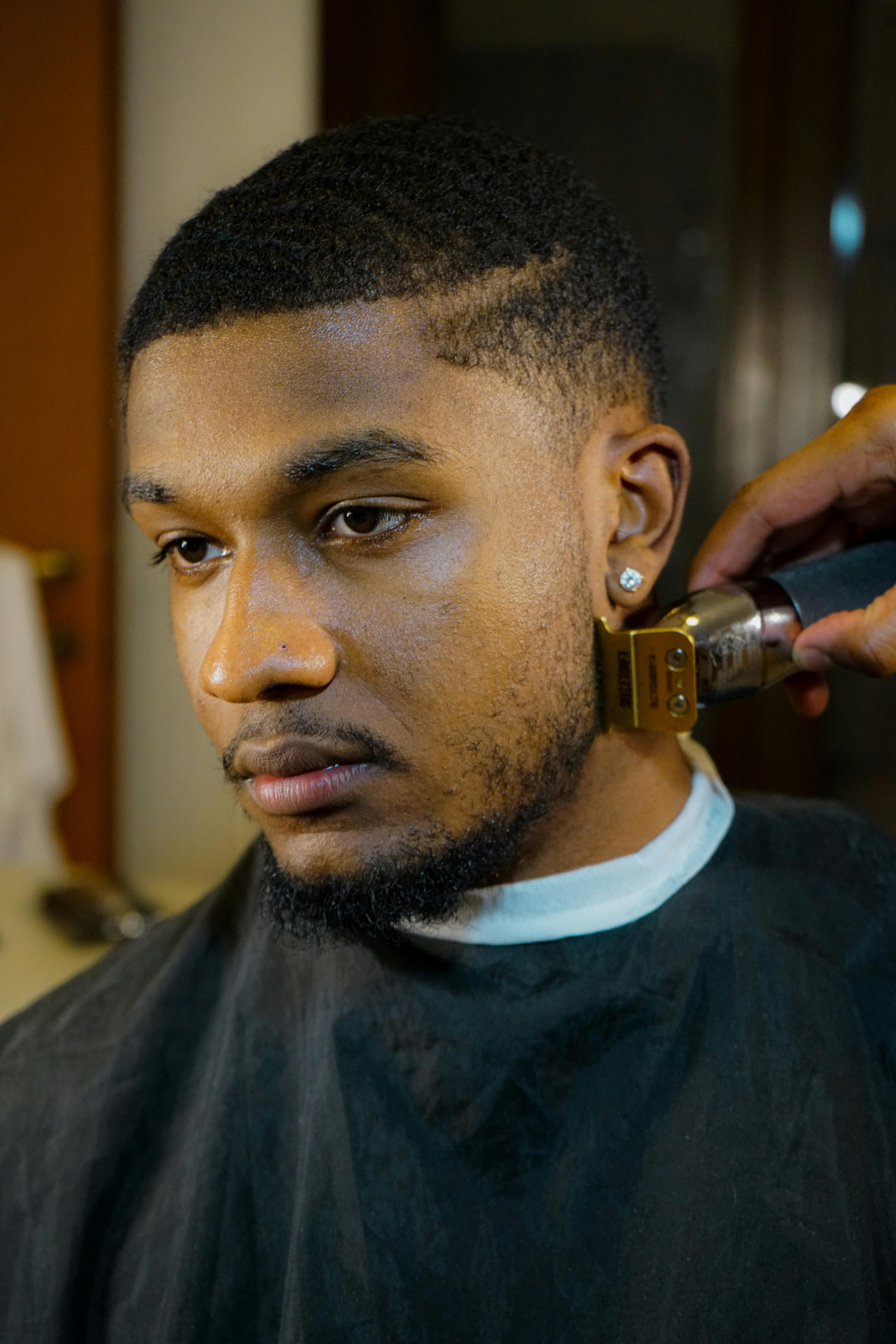 Man in a Barbers Shop Getting his Beard Trimmed · Free Stock Photo