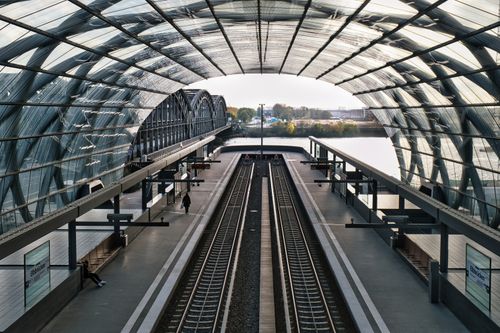 Free Aerial view of a modern railway station in Hamburg with curving glass roof. Stock Photo