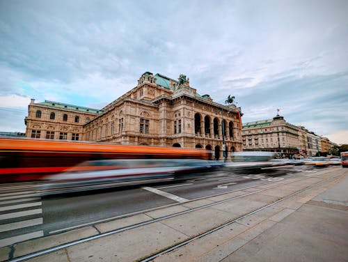 Free Vehicles on the Street in Blurred Motion in front of the Vienna State Opera Building, Vienna, Austria  Stock Photo