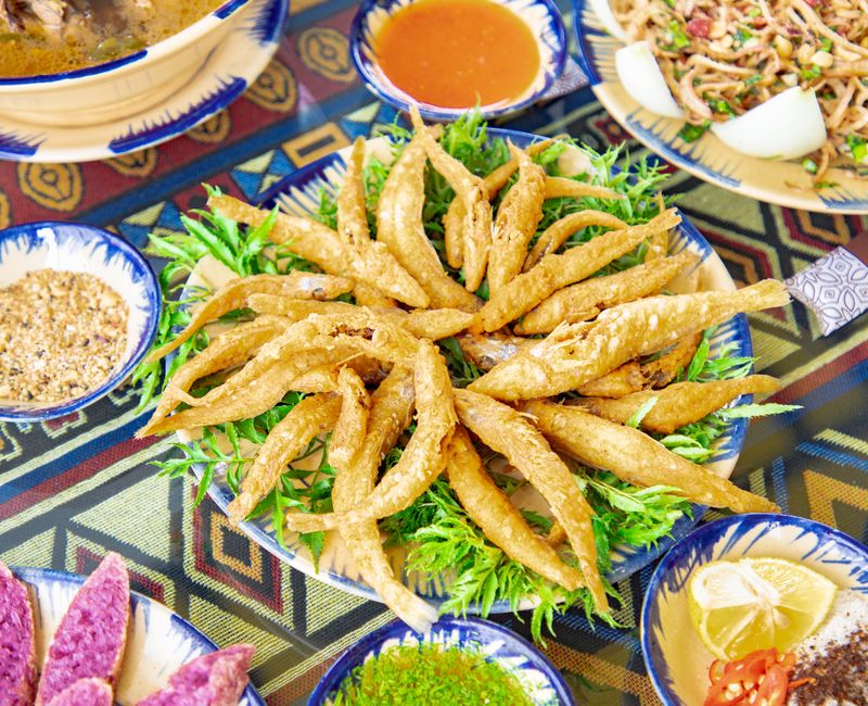 An assortment of traditional Moroccan dishes served on a colorful tablecloth