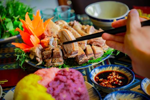 Free Close-up of a colorful Vietnamese meal with chopsticks and dipping sauce. Stock Photo