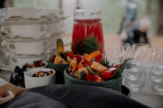 A beautifully arranged table with festive candies and glassware, perfect for a holiday gathering.