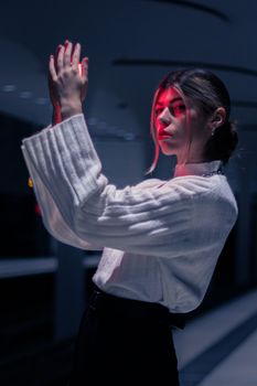 Portrait of a woman at night in Berlin with dramatic neon lighting.
