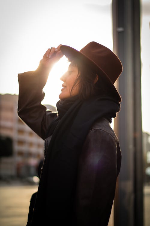 Woman in Hat and Scarf at Sunset