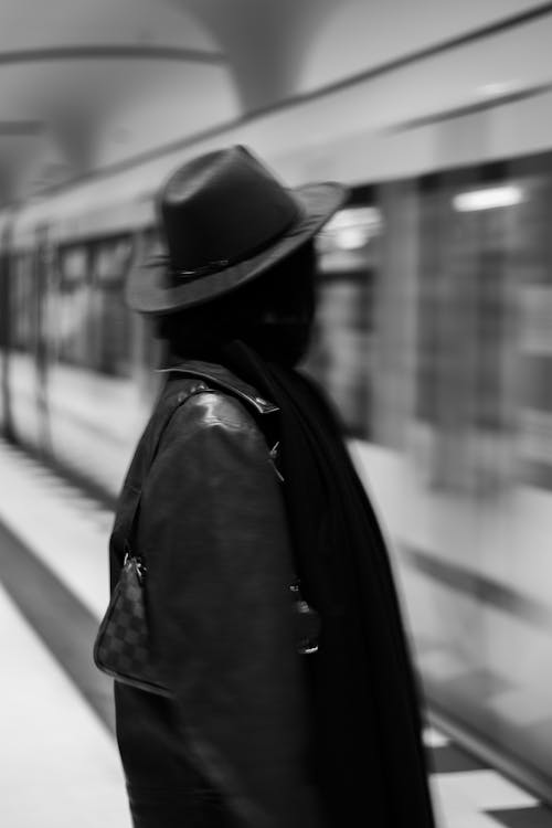 Woman in Jacket and Hat in Subway Station