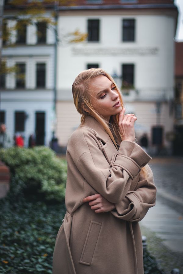 Woman in a camel coat with a ribbed midi skirt