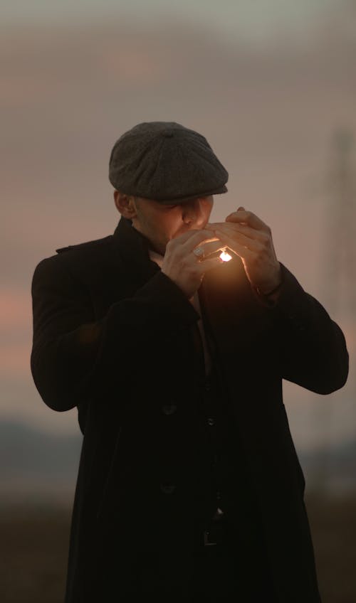 Man in Jacket Lighting Cigarette