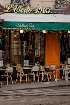 Elegant Parisian cafe with outdoor seating, showcasing classic bistro style and vintage decor.