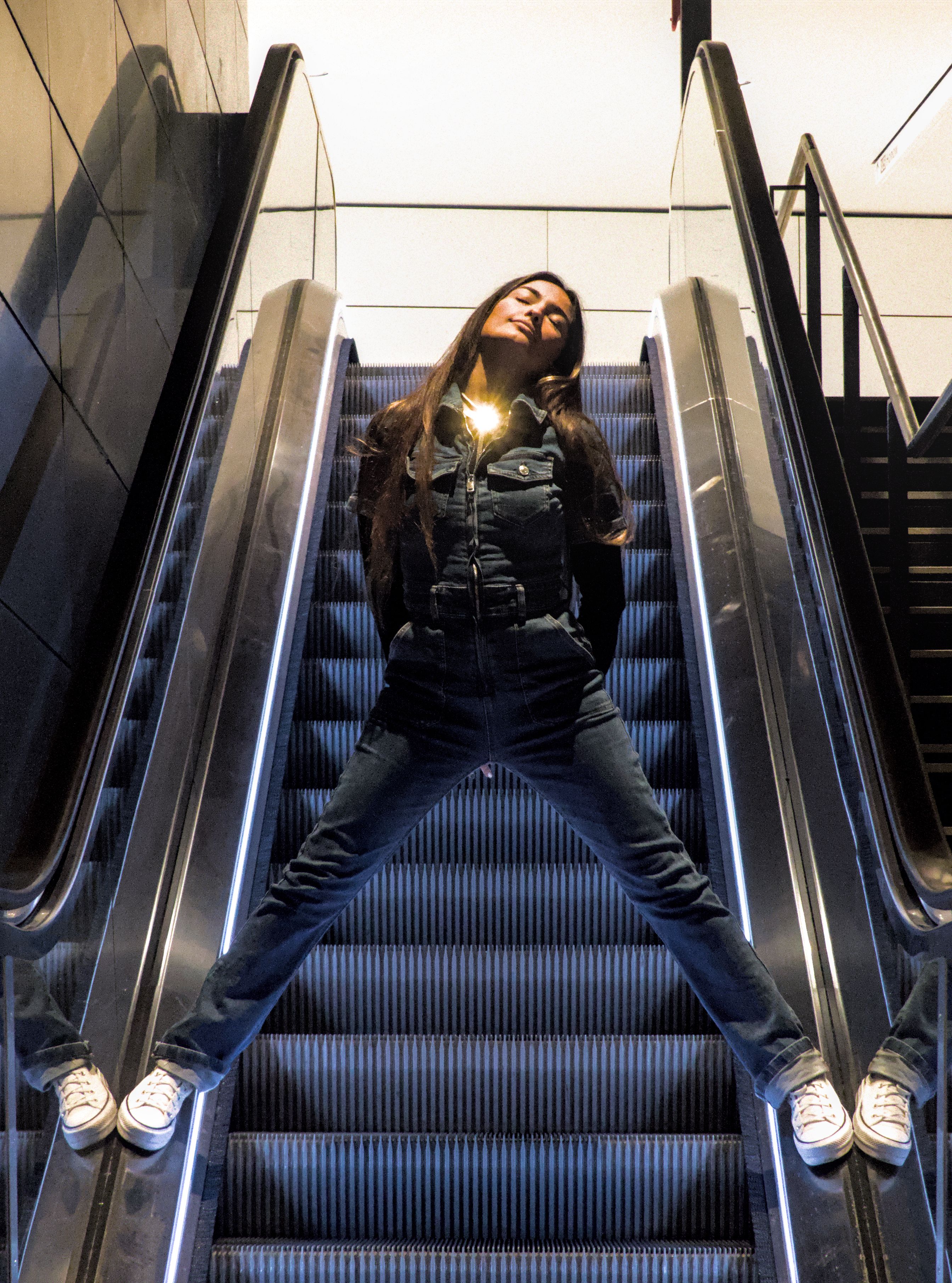 Woman Using Handrail Woman Posing on Escalator Handrails · Free Stock Photo
