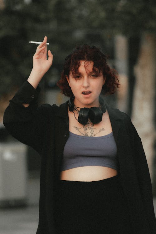 Young Woman Smoking a Cigarette Outside 