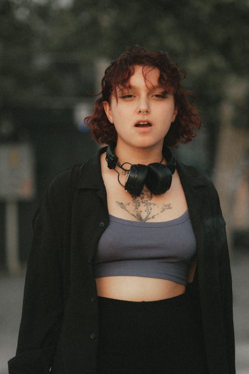 Young Curly Woman Posing in Black Shirt and Gray Crop Top