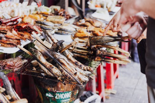 Explore the vibrant display of grilled fish and meats at a bustling street market stall.