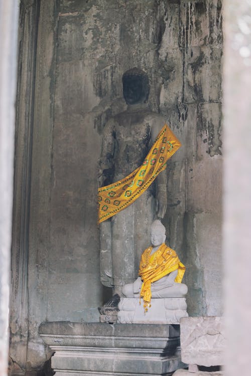 Buddhist Statues Decorated with Yellow Scarves