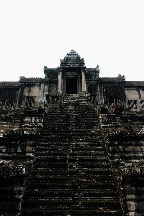 Free Explore the ancient stone steps ascending to Angkor Wat, a UNESCO World Heritage Site in Cambodia. Stock Photo