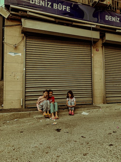 Girls Sitting on Street in Town in Turkey