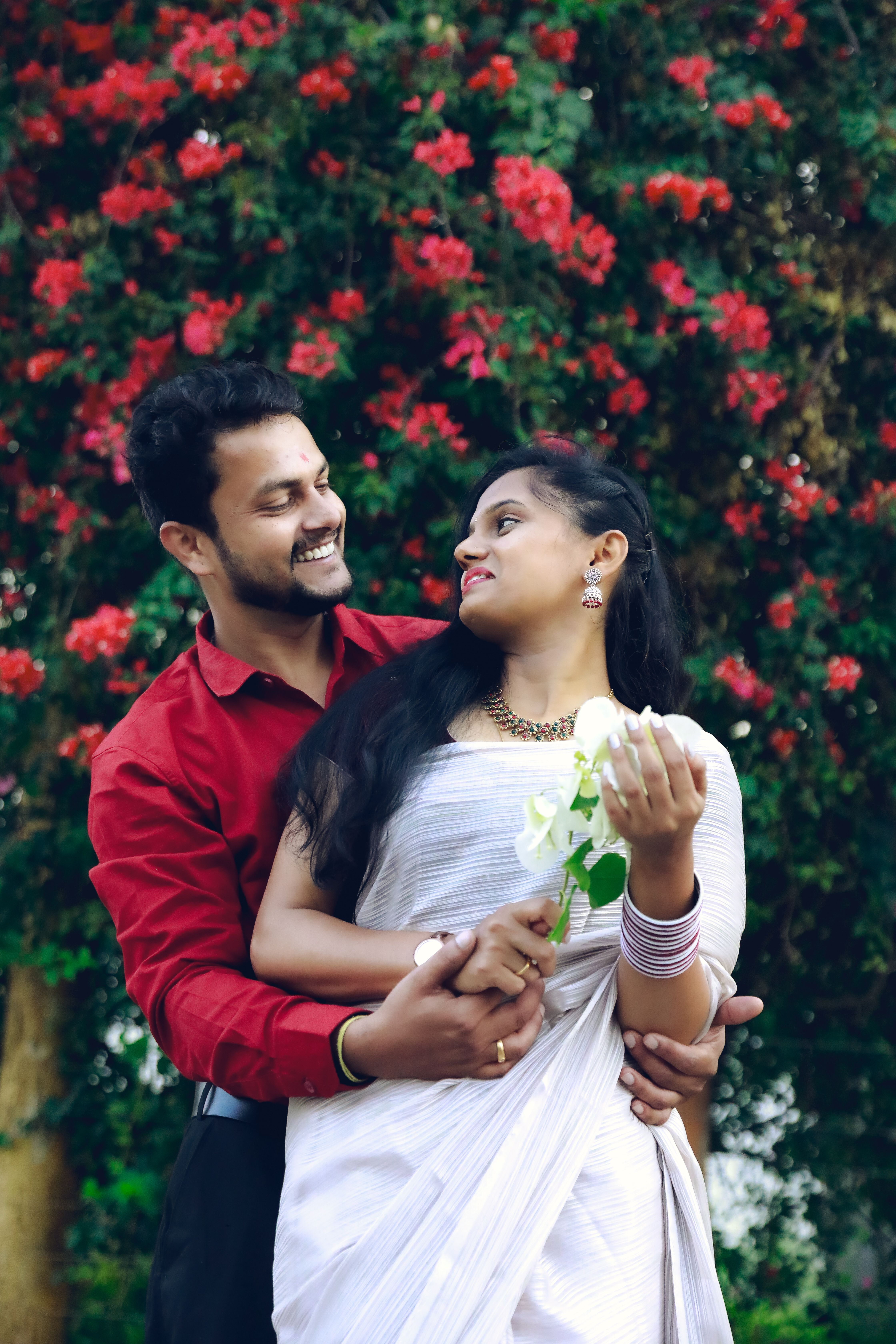 Smiling Couple in Traditional Clothing Hugging · Free Stock Photo