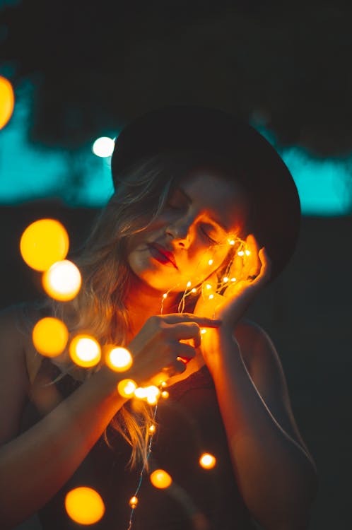 Woman Holding Yellow String Lights