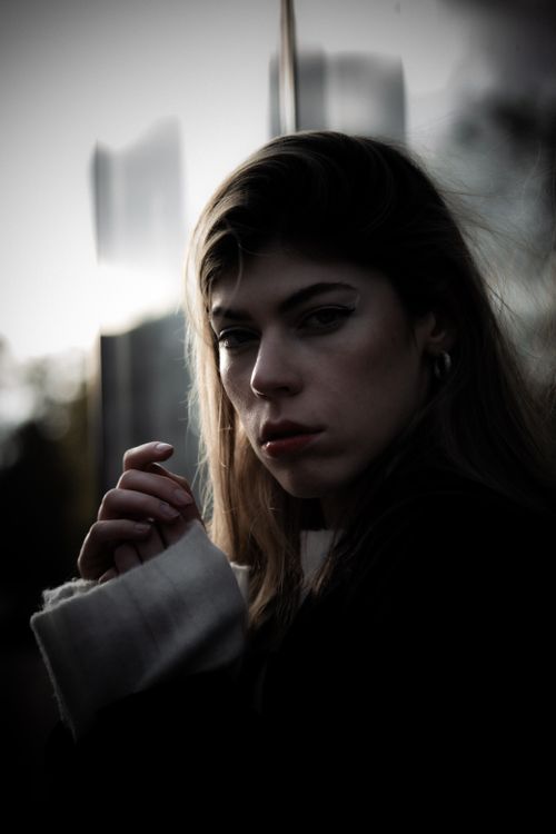 Free Dramatic portrait of a woman with long hair in Berlin, showcasing fashion and moodiness. Stock Photo
