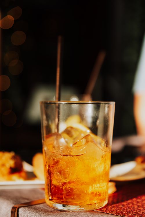 Free Inviting close-up of a whiskey cocktail with ice, perfect for bar and dining settings. Stock Photo
