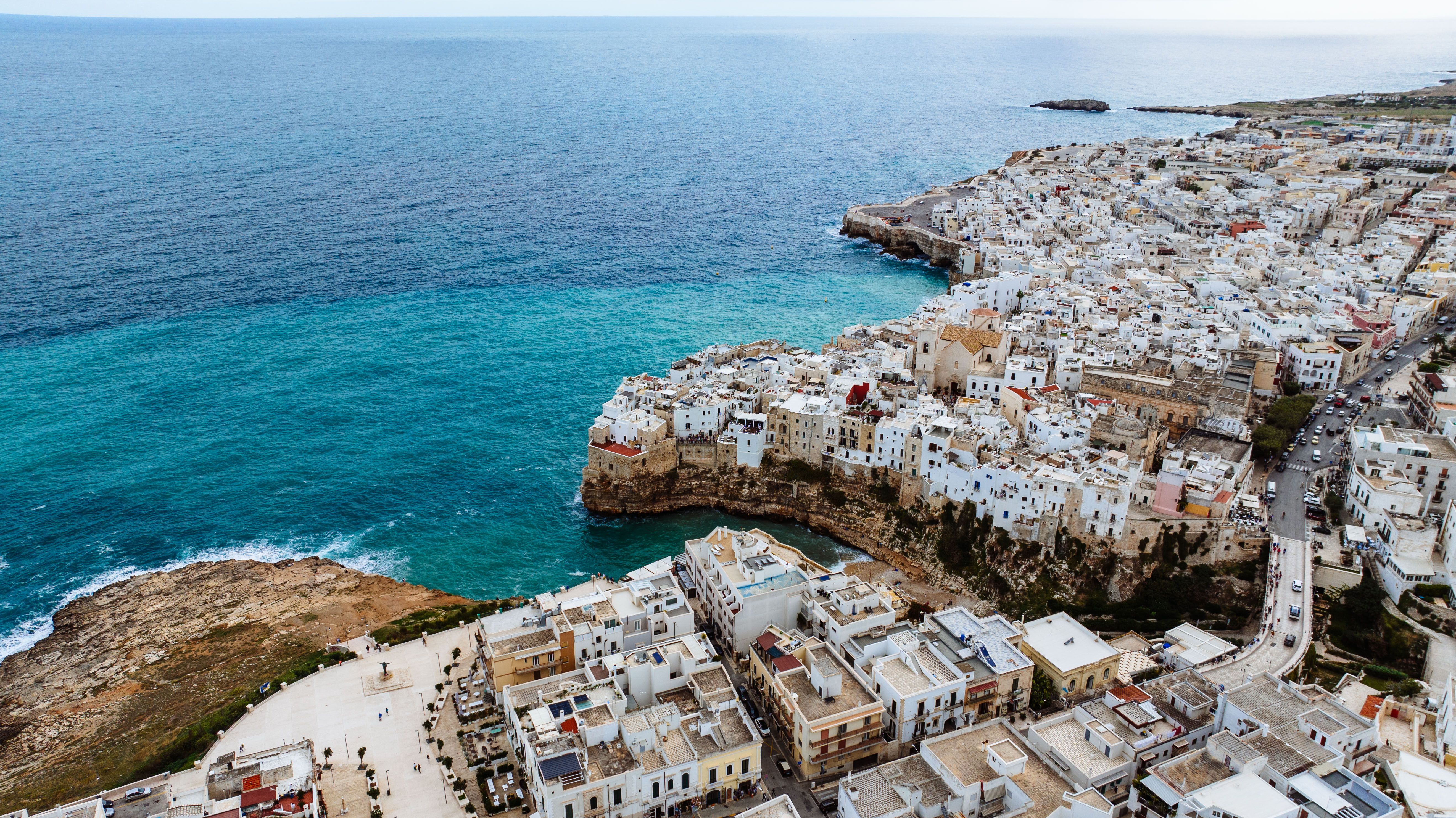 Aerial view of Polignano a Mare's seaside architecture and cliffs.