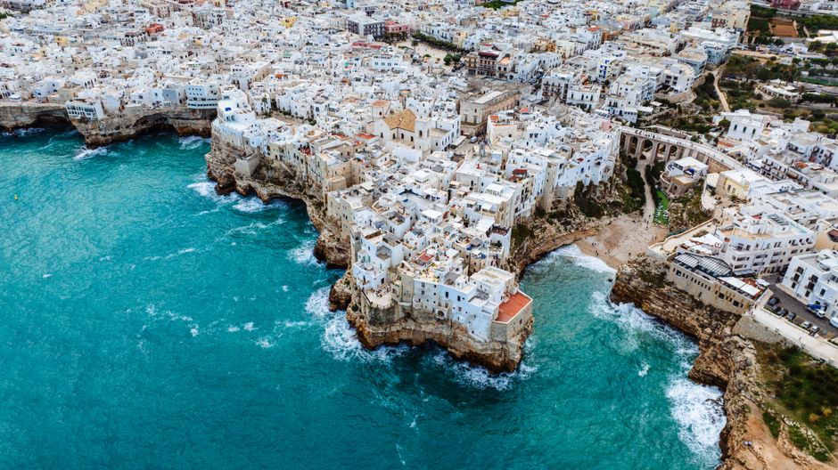 Unforgettable 30 Minutes Etna Volcano Private Helicopter Tour from Fiumefreddo Review Review 2026 - Aerial view of picturesque Polignano a Mare with whitewashed buildings along the Italian cliffs.