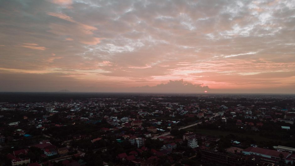 Captivating aerial view of Krong Siem Reap at sunset showing the cityscape and twilight sky.