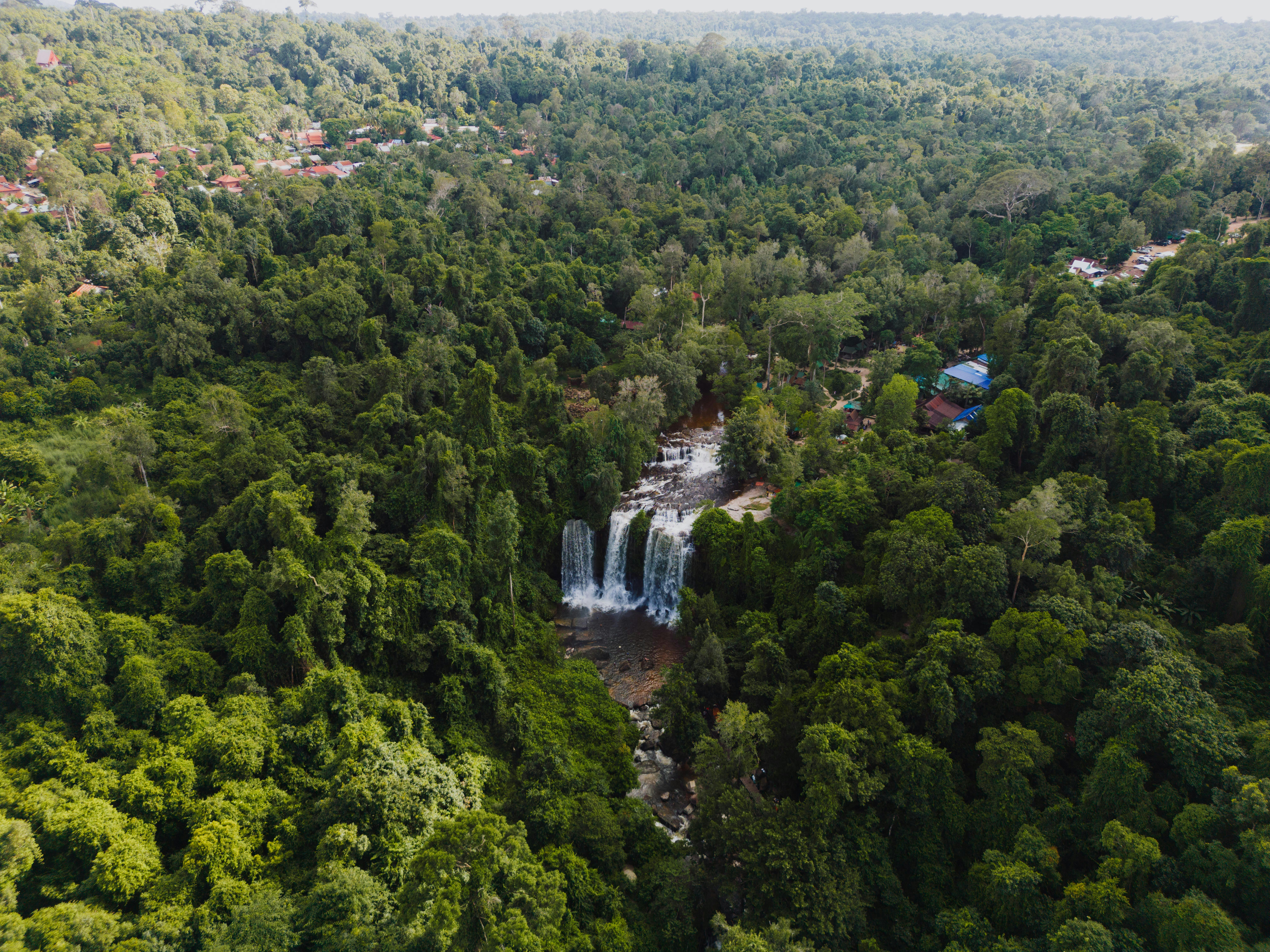 Aerial view of waterfall surrounded by dense forest in Popel Siem Reap Cambodia