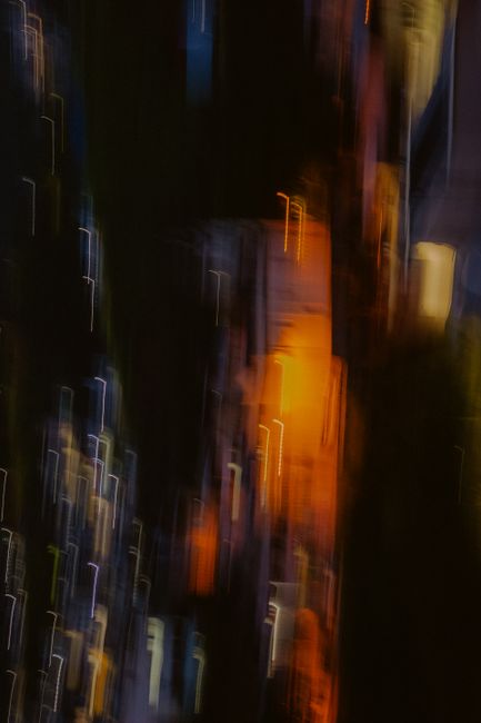 Blurred motion of colorful light streaks creating an abstract night scene.