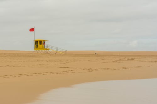 Free stock photo of beach, red flag, sand Stock Photo