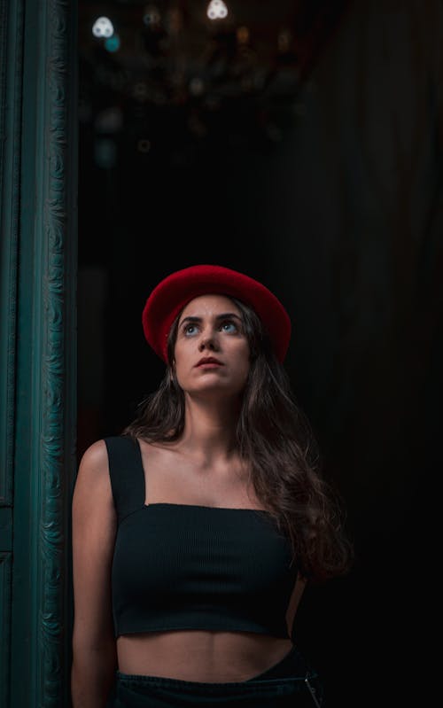 Model in a Red Beret and a Black Crop Top Standing in the Doorway
