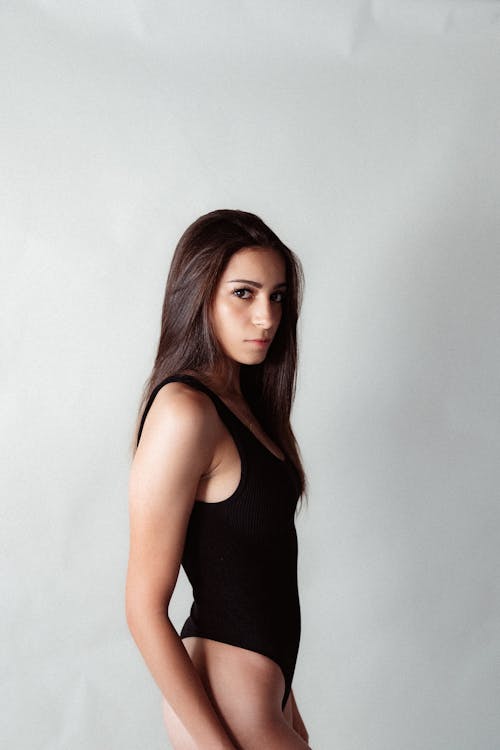 Young Brunette Woman Posing in Black Body Suit