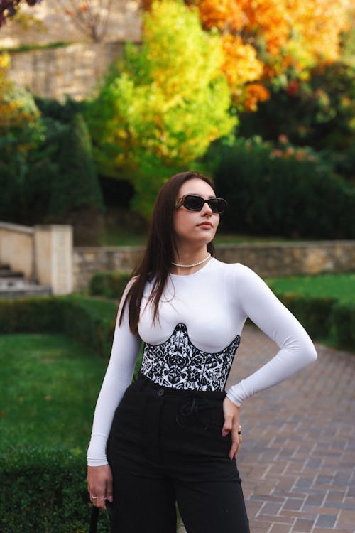 Model in a Printed Corset on a White Blouse in the Park