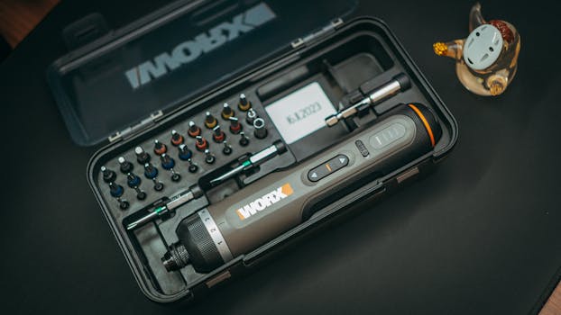 A portable electric screwdriver kit with various precision bits, ideal for tech repairs.