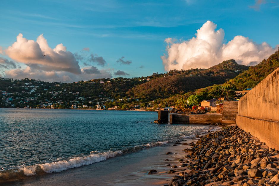 Beautiful coastal town with hills and cloudy sky, perfect travel spot.
